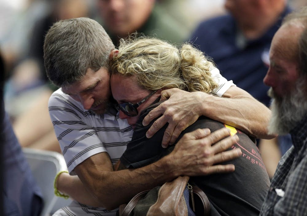 A couple embraces during a memorial service