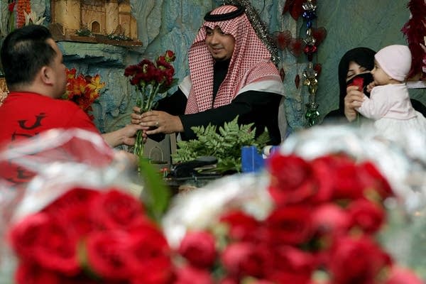 A Saudi man buys red roses for his wife at a flower shop in Riyadh.