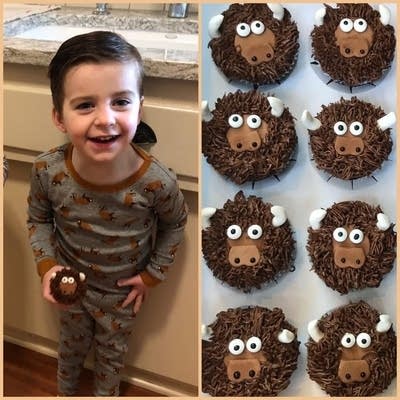 A child holds a cupcake that looks like a cartoon bison.