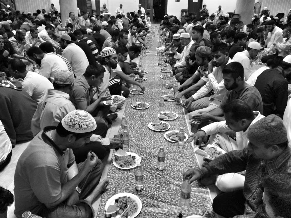 Muslim men break fast with Iftar
