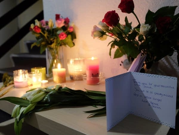 Tributes are placed on a table in an apartment building