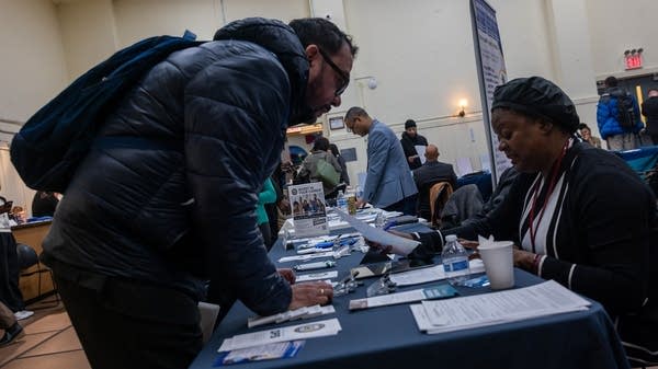 Many of the people who are considered long-term unemployed are educated professionals with strong resumes, caught in a job market that's largely stalled. Above, job seekers at a career fair in Harlem.
