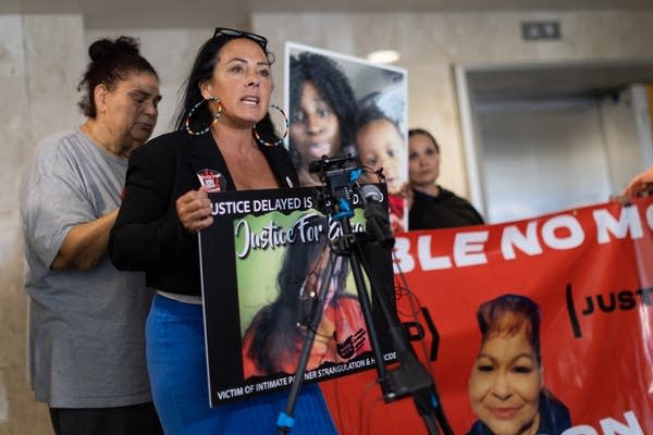 A woman talks to the press