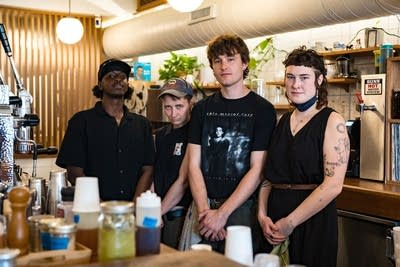 Group of people standing behind bar