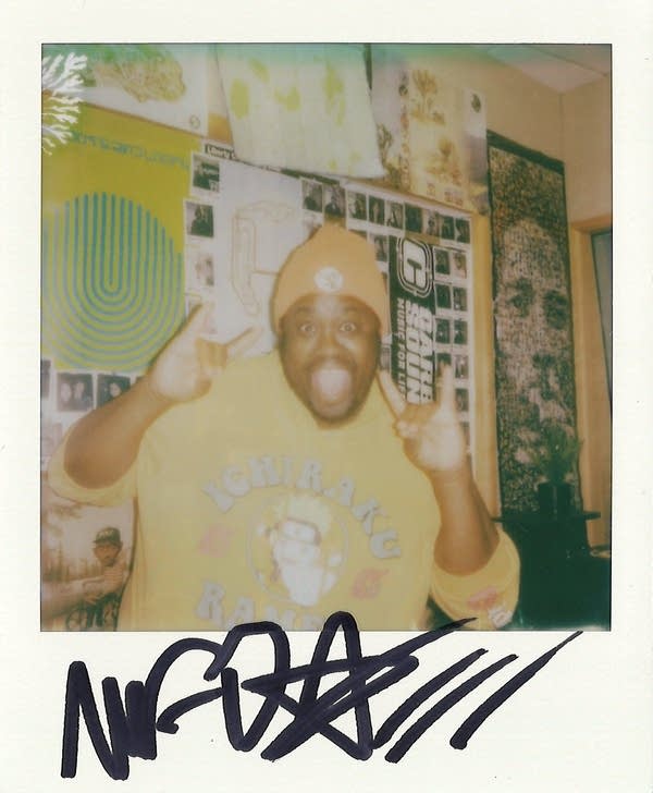 a man posing for a polaroid photo in the carbon sound studio