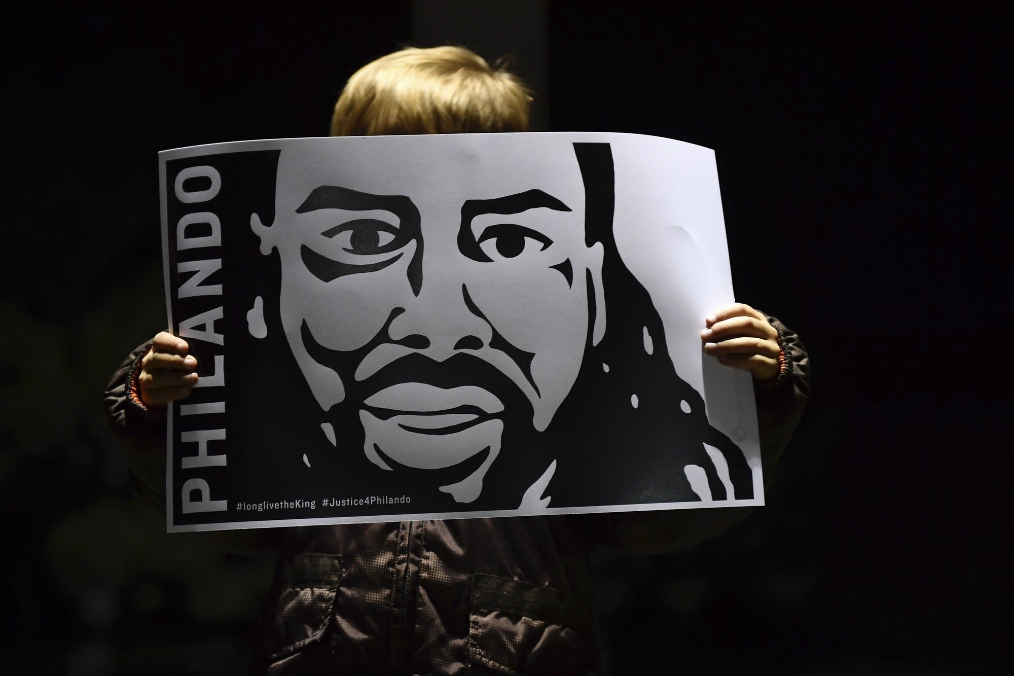 Judah O'Hara holds an image of Philando Castile.