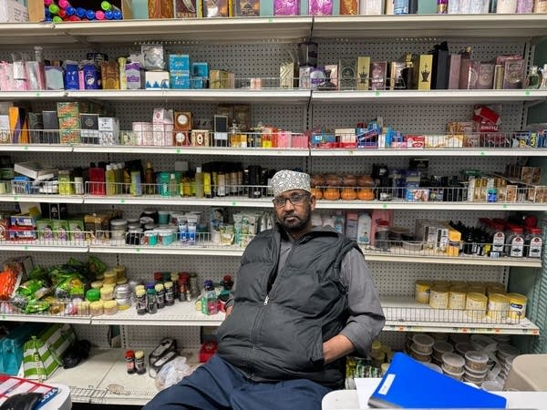 man behind counter of business
