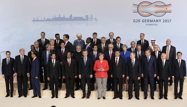 Participants pose for a group photo on the first day of the G-20 summit