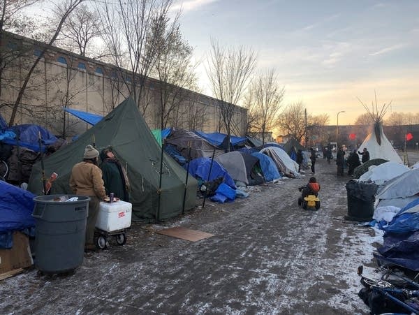 Residents of Minneapolis’s homeless encampment erect arctic tents.