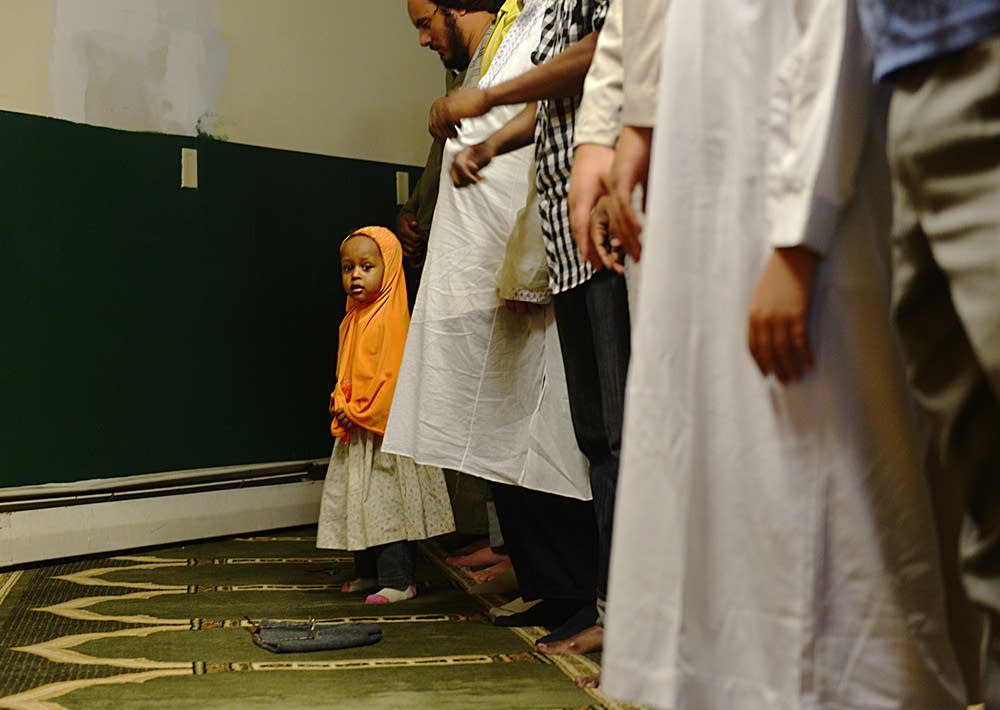 Girl peeks out during prayer