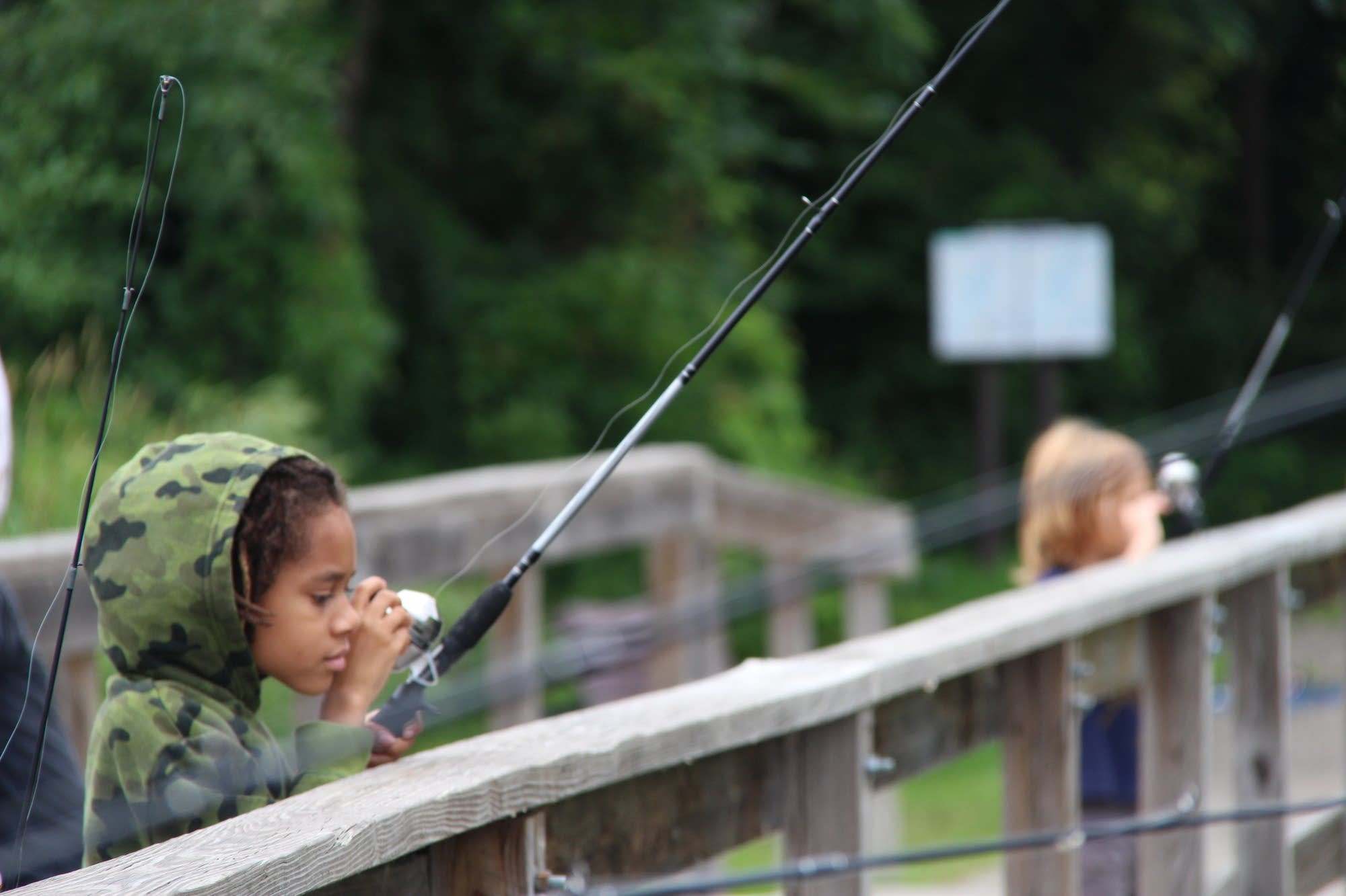 Amitri Hosea watches his line after casting into Snelling Lake.