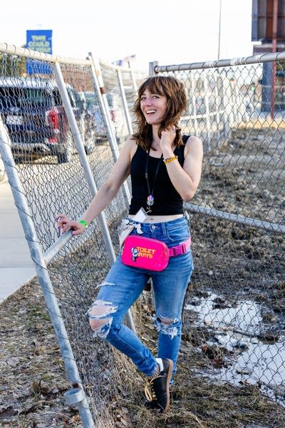 A photographer stands outdoors for a casual portrait