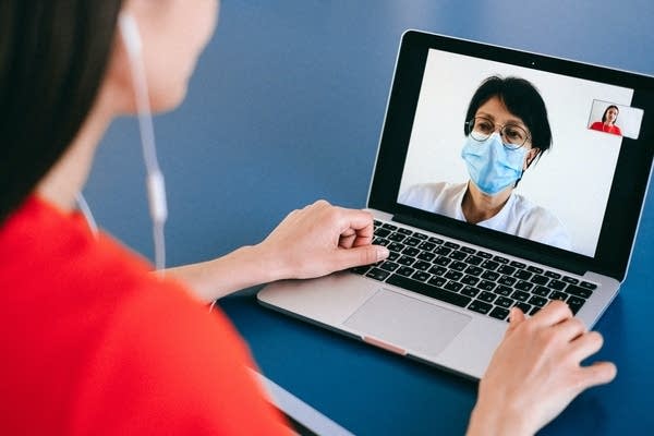 Two people talk on a video call.