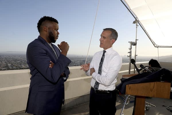 Two men face each other during a conversation