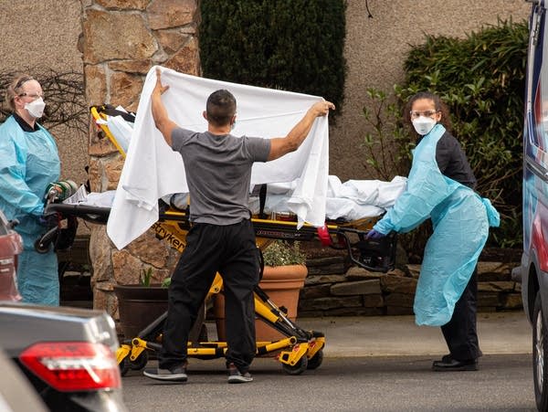 Health-care workers transport a patient on a stretcher 