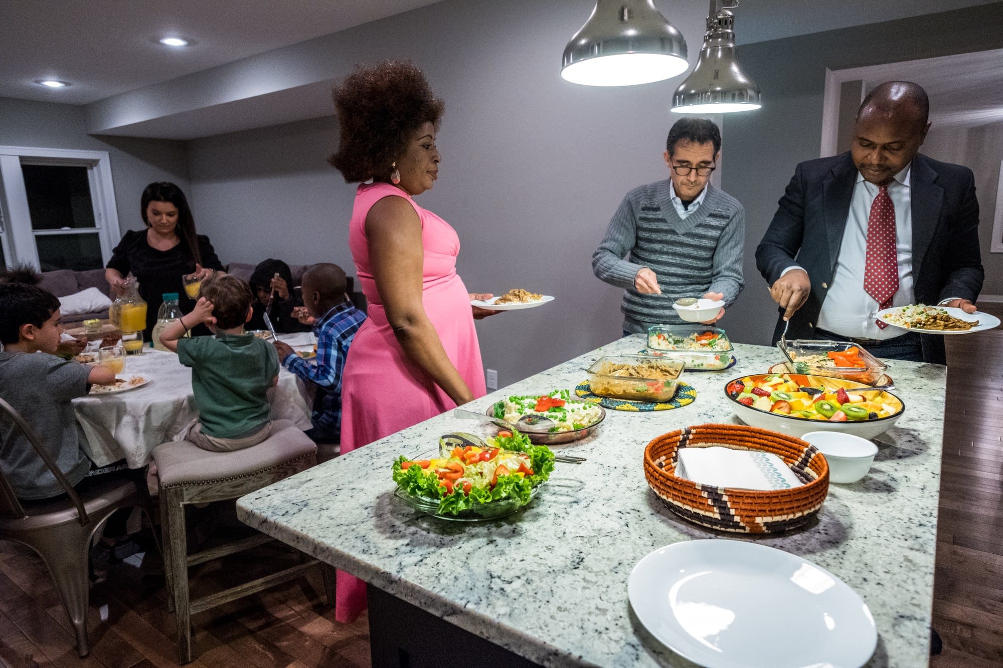 The two families enjoy dinner together.