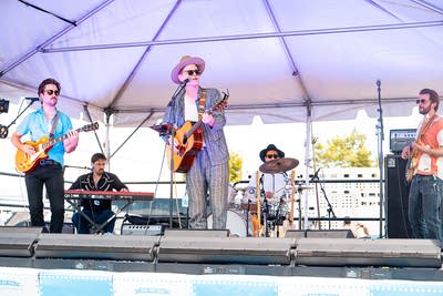 A band performing on an outdoor stage