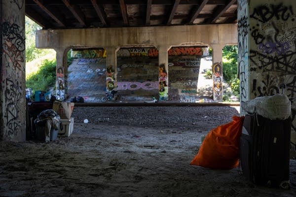 Bags wait next to a train track