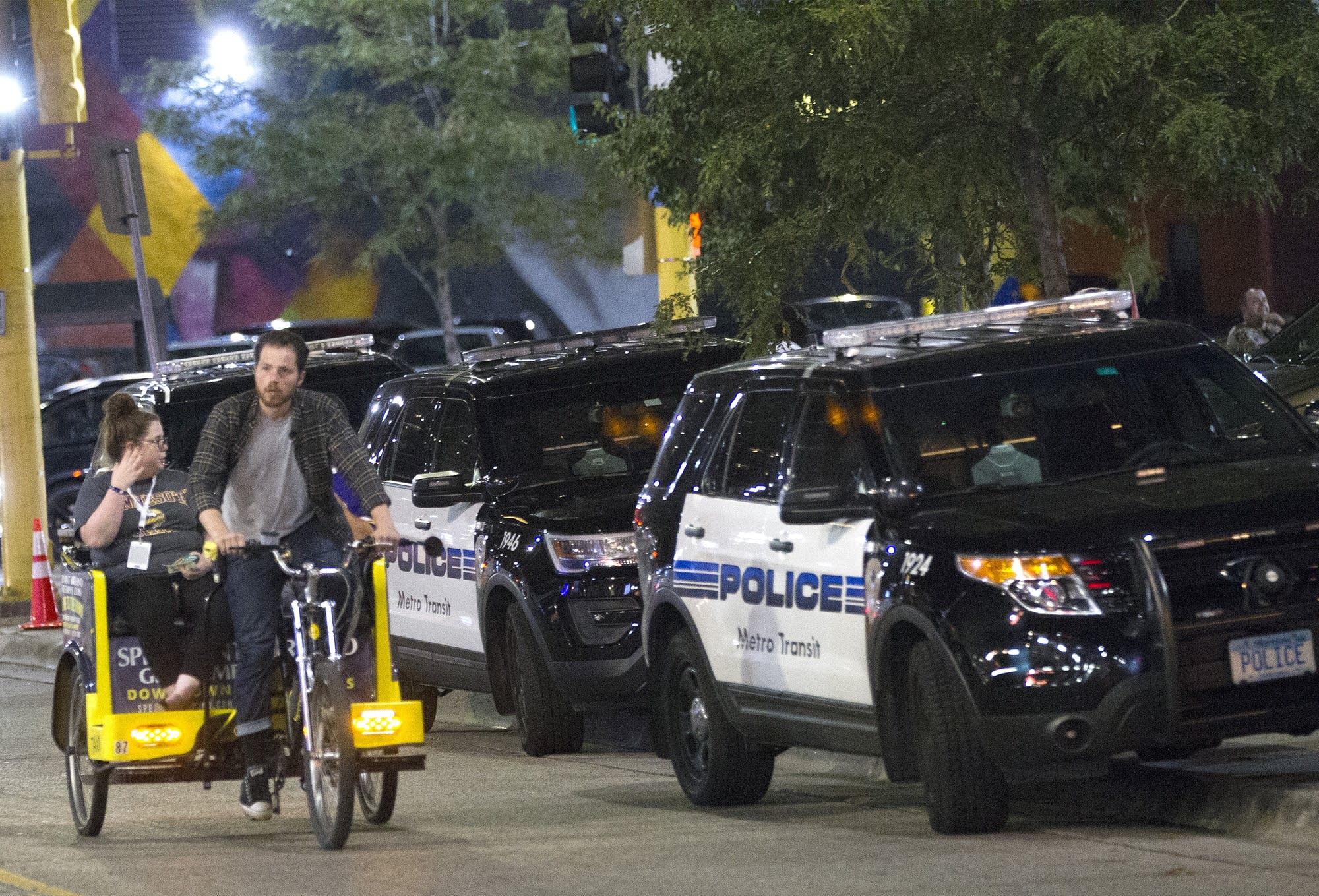 A pedicab driver transports a passenger along N. 5th St.