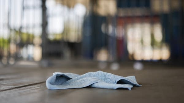 A wash rag lies on the ground of a car wash.