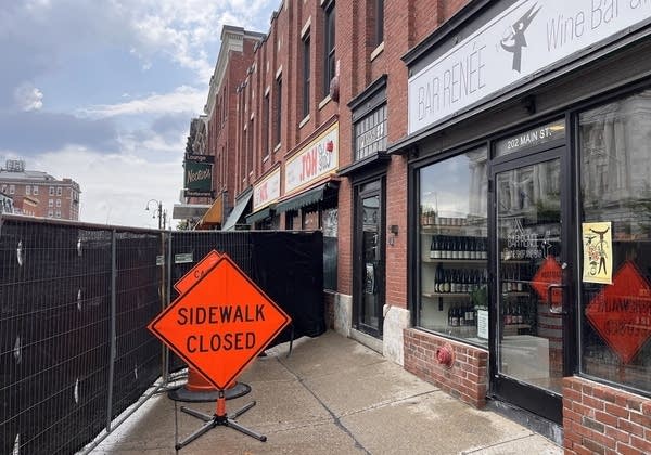 A "sidewalk closed" sign sits outside businesses on Main Street in Burlington, Vermont.