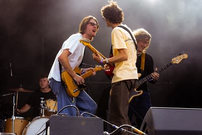 Common People performing on an outdoor stage.