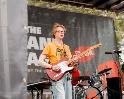Person playing guitar on stage