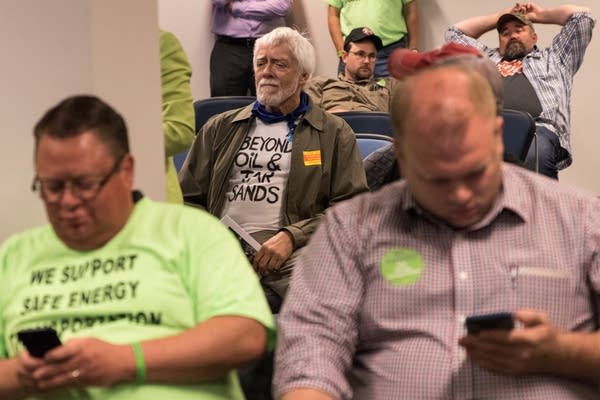 Line 3 proponents and opponents wait for the hearing to begin.