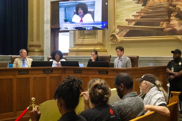 Minneapolis City Council members sitting at desk