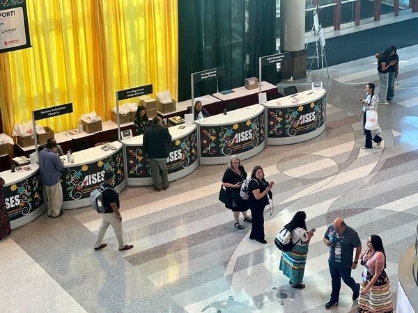 Wide aerial shot of conference registration desks.