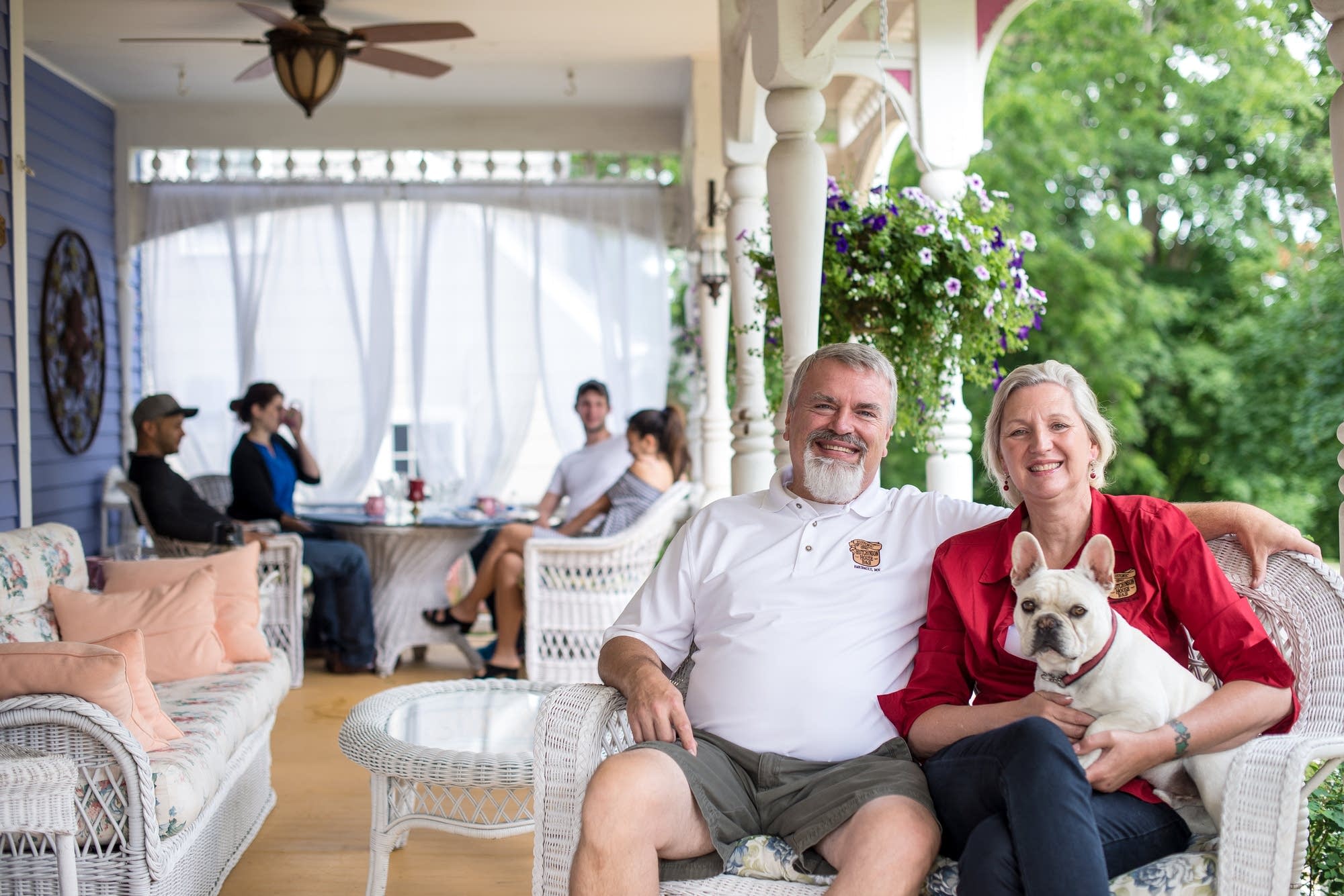 Doug and Tami Schluter on the porch of their bed and breakfast