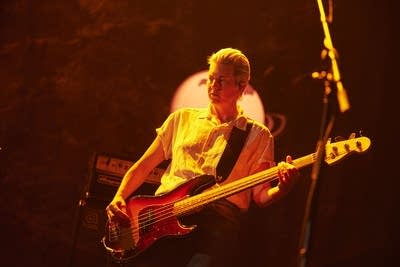 a woman with a bass performing on stage