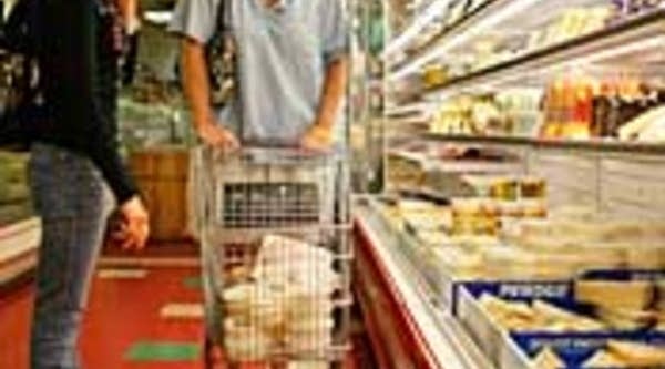 Renae Geraldi, left, and C.J. Miller shop for groceries at Lorenzo's Supermarket in North Miami, Fla.