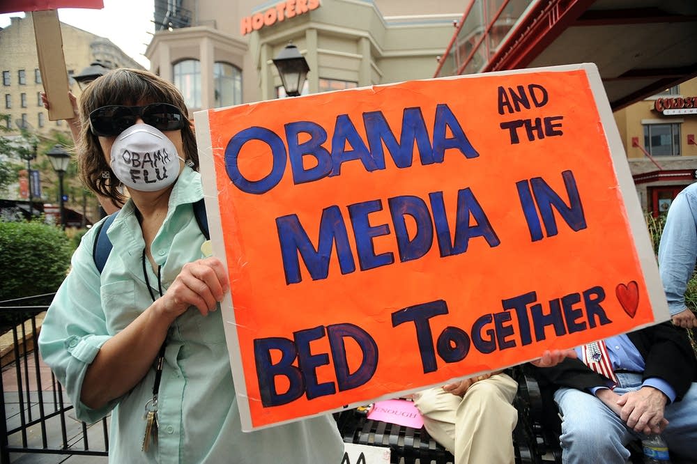 A protester holds up a sign