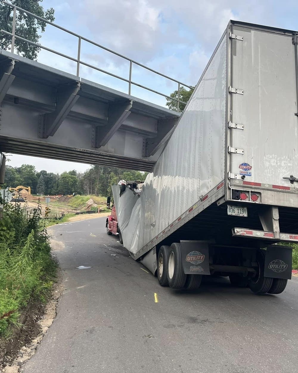 Semi driver gets lost, then gets stuck under bridge in Cottage