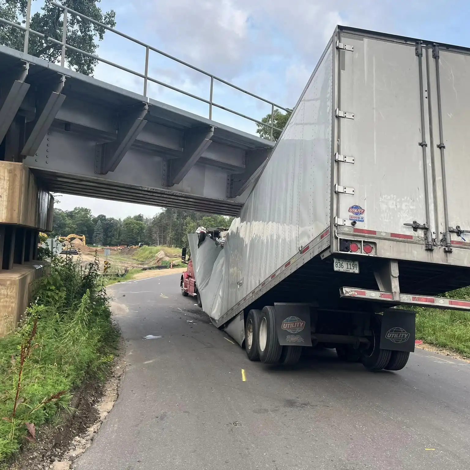 Semi driver gets lost, then gets stuck under bridge in Cottage 