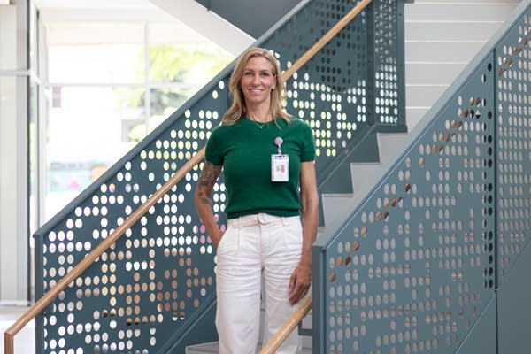 A woman poses for a photograph on a stairway.