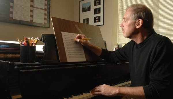 Poster Rene Clausen composes at the piano.