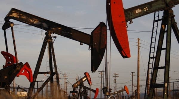Pump jacks and wells are seen in an oil field using fracking.