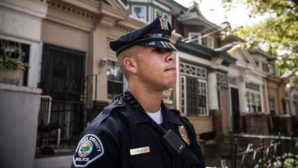 Officer Adam Fulmore, of the Camden County Police Department, goes on a foot patrol on August 22, 2013.
