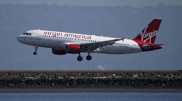 A Virgin America plane lands at San Francisco International Airport on March 29, 2016 in Burlingame, California. JetBlue Airways and Alaska Air Group are reportedly preparing takeover offer bids for Virgin America airlines.
