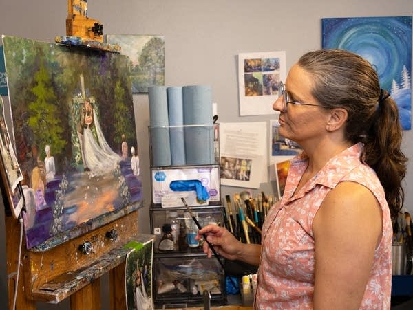 a woman looks at a painting