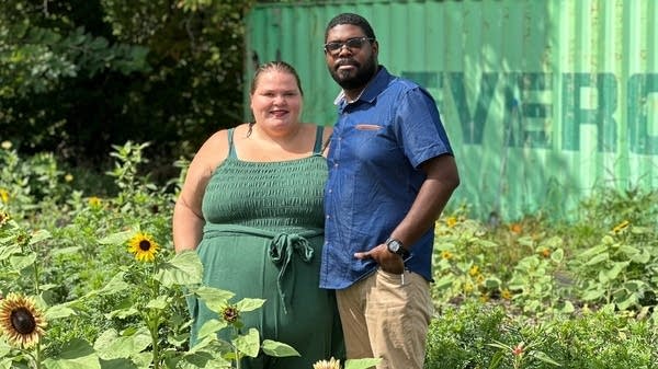 Marisa Mender-Franklin and her husband, Corey Franklin, in one of their gardens, built on an empty lot. Property owners lend her growing space in exchange for flowers and land care.