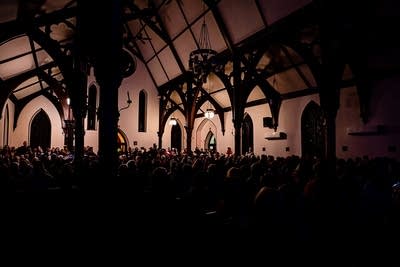Music fans fill a church being used as a venue at a music festival