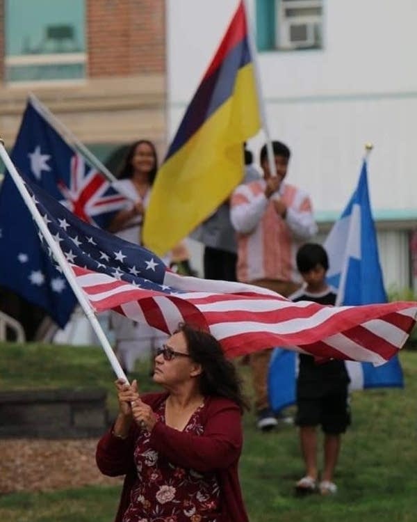 A woman holds an American flag.