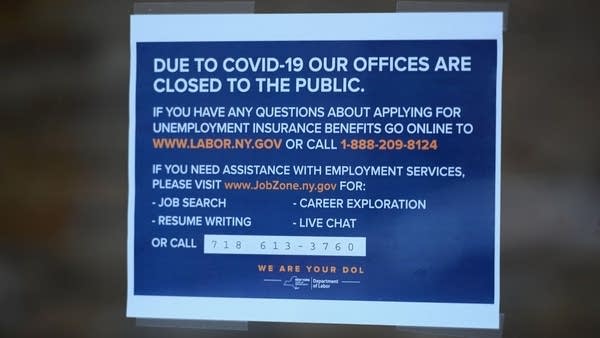 A sign is seen in front of the closed Department of Labor on March 25, 2020 in New York.