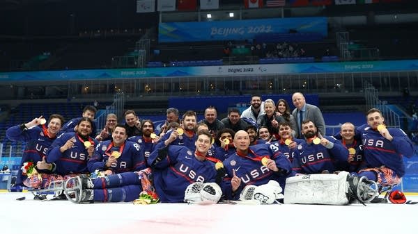 The U.S. sled hockey team celebrates at the medal ceremony of the 2022 Beijing Winter Paralympics.