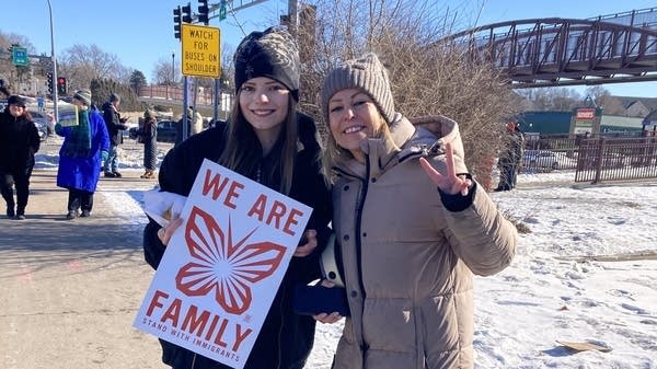 Protesters hold up sign