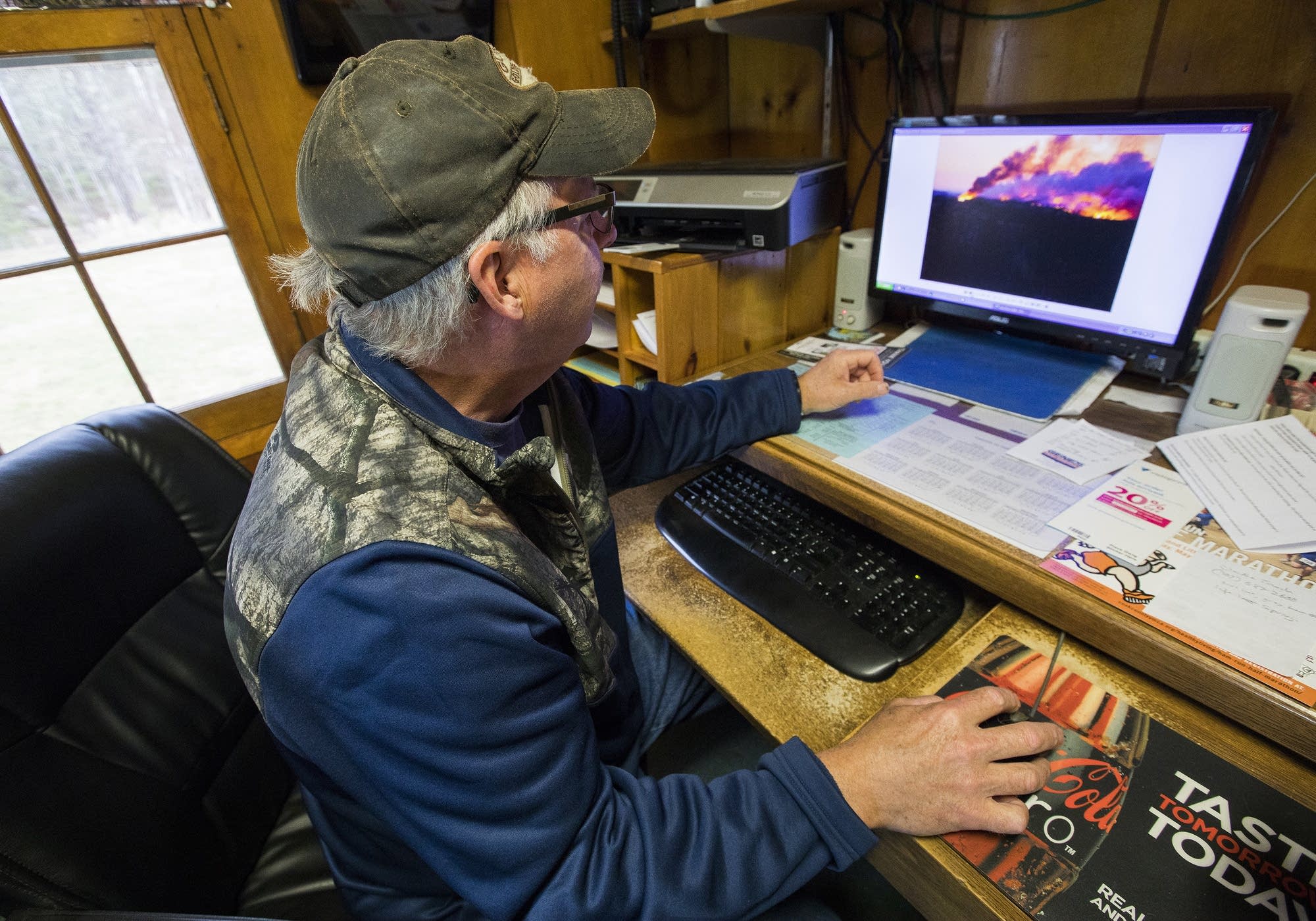 Dan Baumann looks through photos he took during the fire.