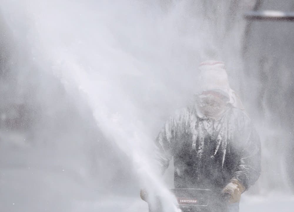 Jim Koran blows snow at his home in St. Paul.
